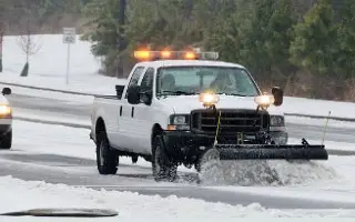 Cleared parking lot by a plow truck from Rockytop Construction offering Commercial Snow & Ice Management in Calgary